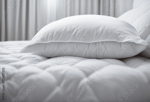 White folded duvet lying on white bed background Preparing for winter season household domestic acti photo