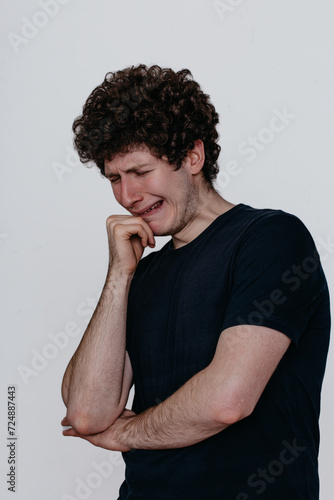 Wallpaper Mural A man in a black T-shirt is very unhappy, conveys the emotion of grief and despair Torontodigital.ca