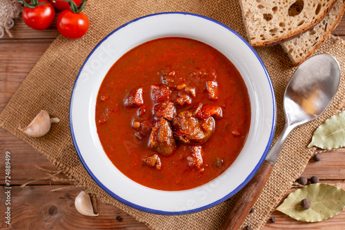 Hearty homemade goulash soup on a table. Copy space