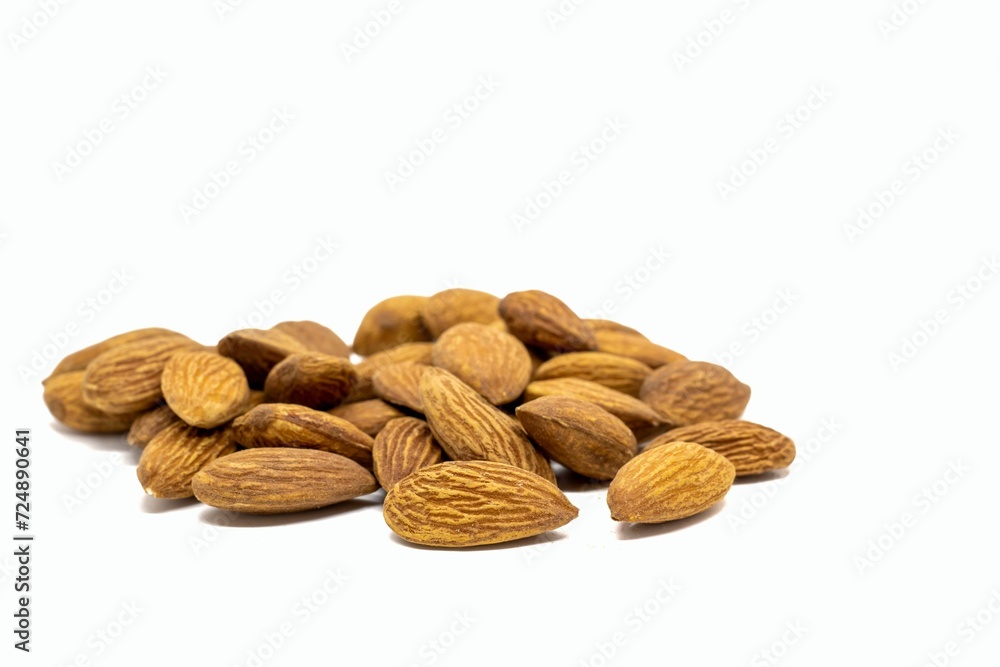 Closeup of Almond Heap Isolate on White Background with Copy Space, Healthy Eating and Lifestyle Concept Closeup of Almond Heap Isolate on White Background with Copy Space, Healthy Eating and Lifestyle Concept