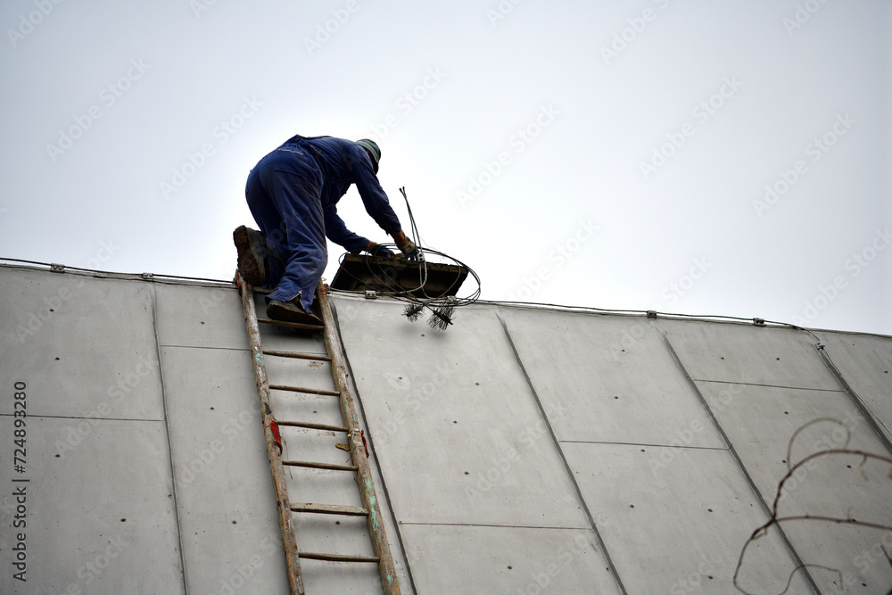 Traditional manual method of cleaning the chimney on the roof