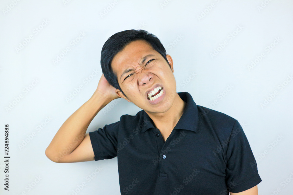 funny facial expression of stressed asian man holding his head, isolated on white background funny facial expression of stressed asian man holding his head, isolated on white background