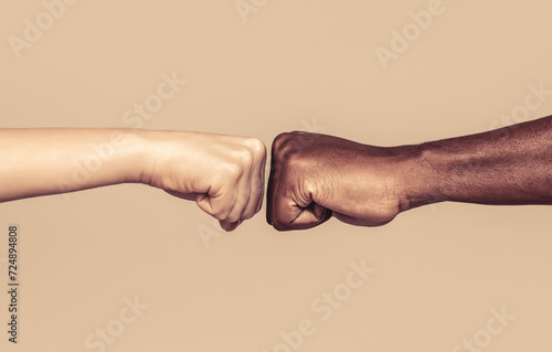 Friendship, team, good work. Closeup friends giving fist bump to each other. Black african american race male and woman hands giving a fist bump, multiracial diversity, immigration concept photo