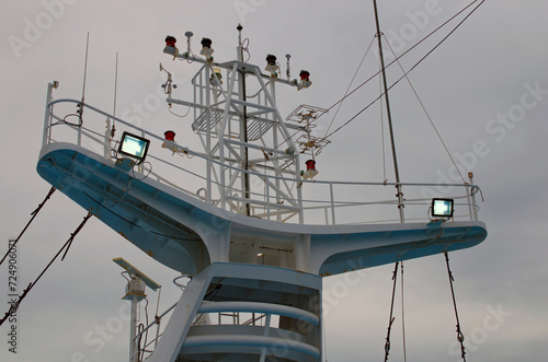Radars on the top cruise liner deck. Close-up view of navigation equipment, antennas and searchlights on the deckhouse of an ocean liner. Control navigation set antennas at the top of the cruise ship