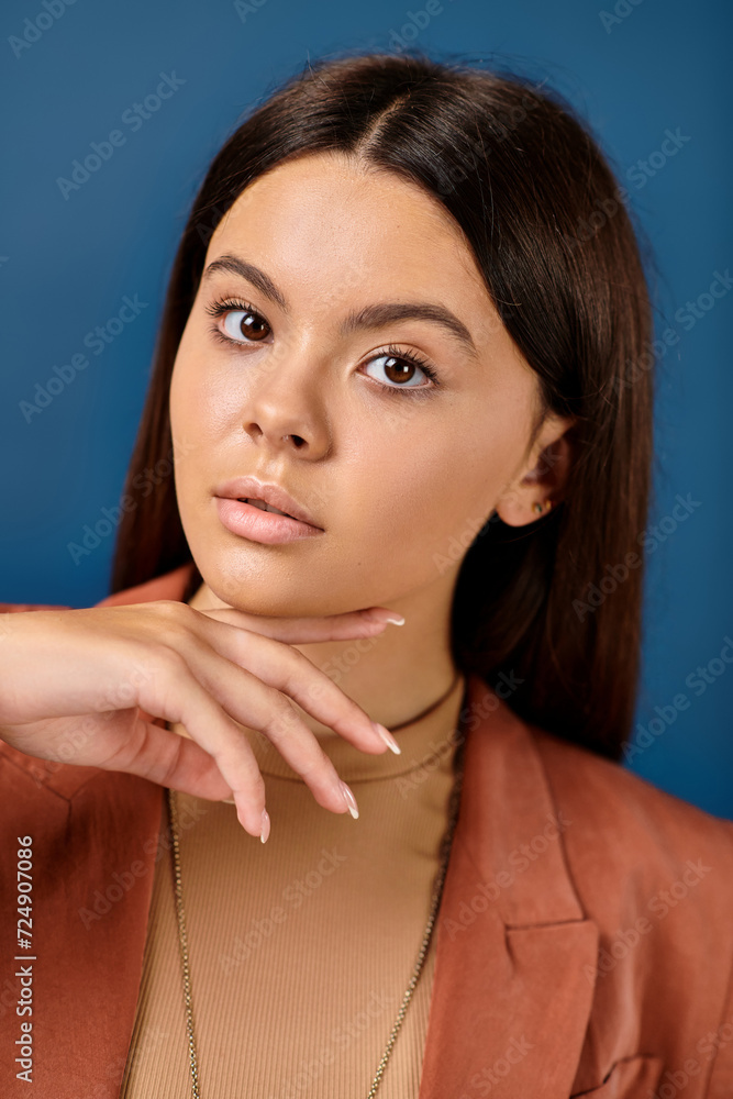 portrait of good looking teenage girl in elegant brown blazer posing and looking at camera