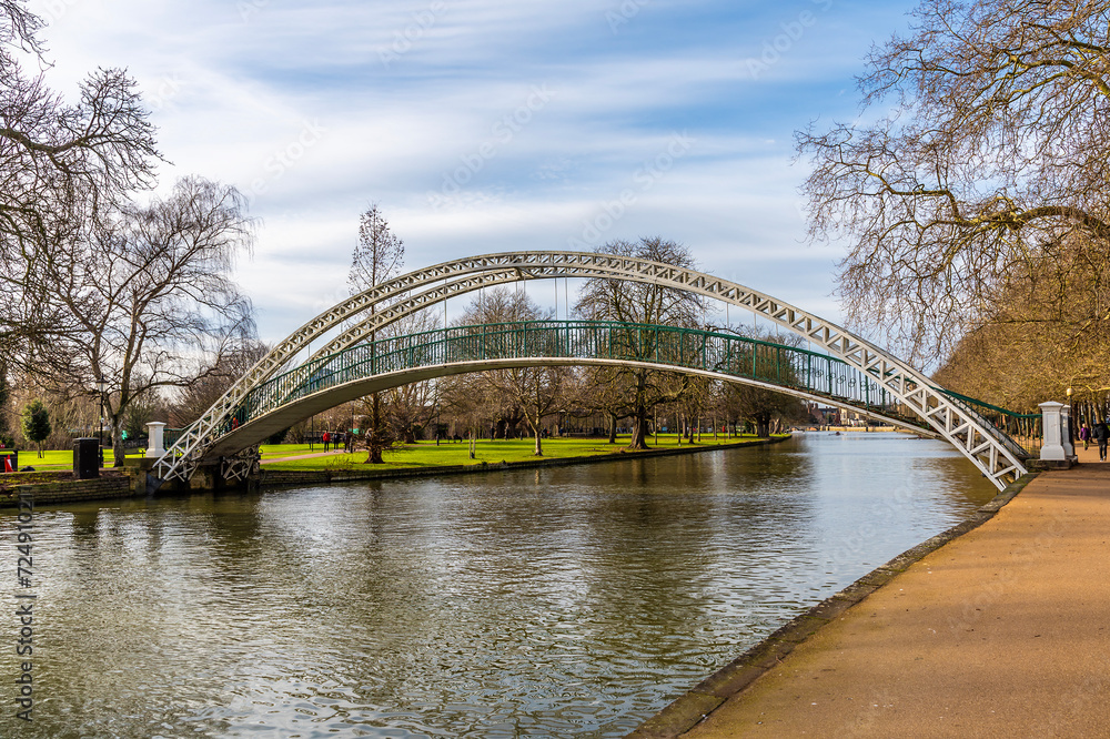 A view up the River Great Ouse towards the suspension bridge in Bedford, UK on a bright sunny day