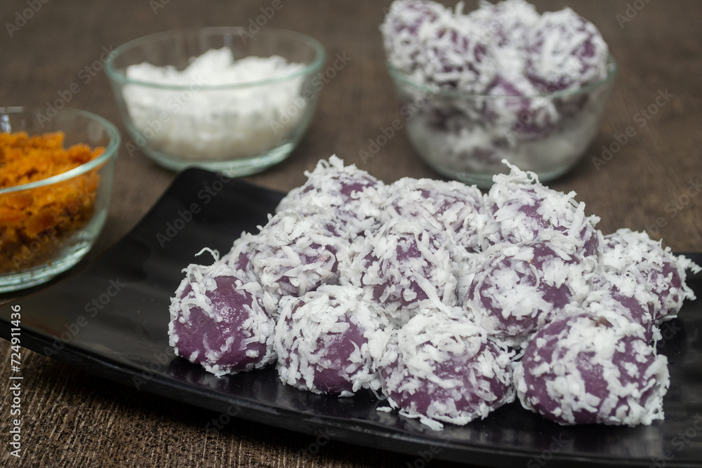Klepon ubi ungu is a snack made of purple sweet potato filled with palm sugar and covered with grated coconut. one of the most popular traditional cakes in Indonesia Klepon ubi ungu is a snack made of purple sweet potato filled with palm sugar and covered with grated coconut. one of the most popular traditional cakes in Indonesia