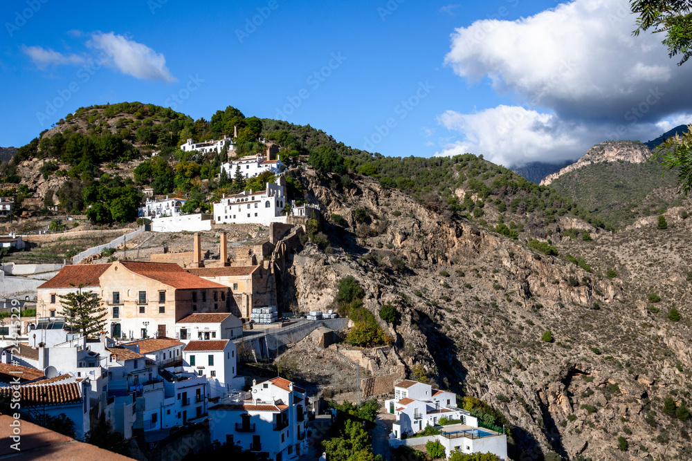 White houses on the slopes of the mountains. Panoramic view of the village of Frigiliana, Andalusia, Spain.