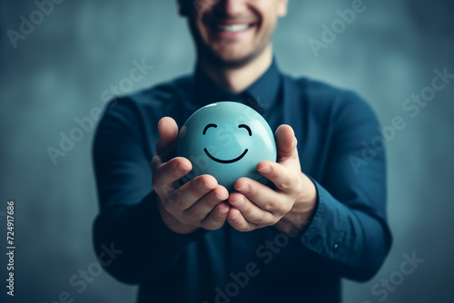 Hands Holding Blue Smiley Face Representing Positivity Satisfaction and Happiness Mental Health Concept