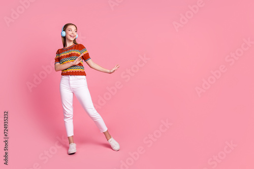 Full size photo of carefree positive person dancing enjoy listen music headphones empty space isolated on pink color background