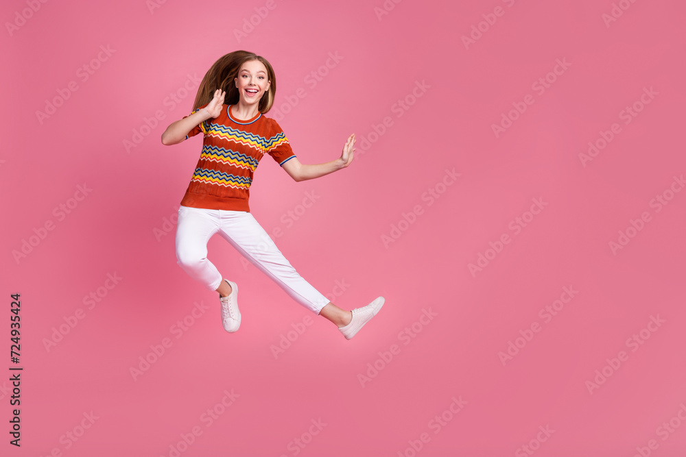 Full length photo of active excited person jump kick fight empty space isolated on pink color background