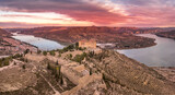 Mequinenza castle panoramic aerial view above the riba roja reservoir in Aragon Spain with dramatic colorful sky
