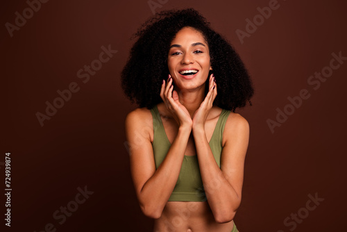 Studio no retouch photo of excited funky lady dressed lingerie applying cream empty space isolated brown color background