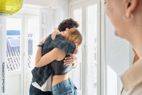 Happy couple hugging each other at home photo