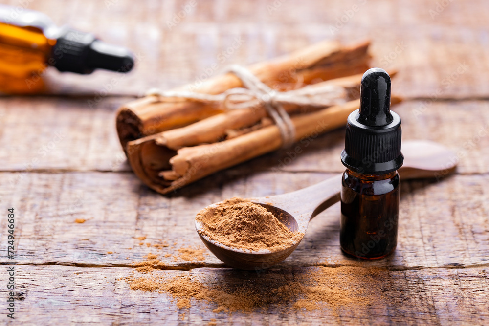 Splinters, powder and essence of cinnamon, on the old table Splinters, powder and essence of cinnamon, on the old table