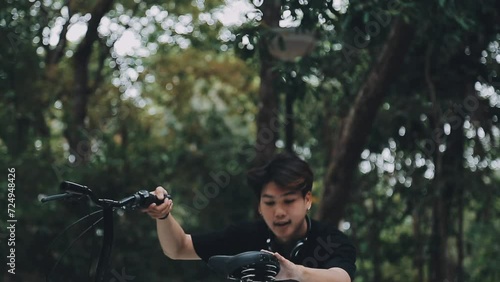 Wallpaper Mural Healthy and active lifestyle, going to work on eco transport. Smiling attractive millennial male employee in glasses with bag and cup of takeaway coffee, moving bike in city park in summer, outdoor Torontodigital.ca