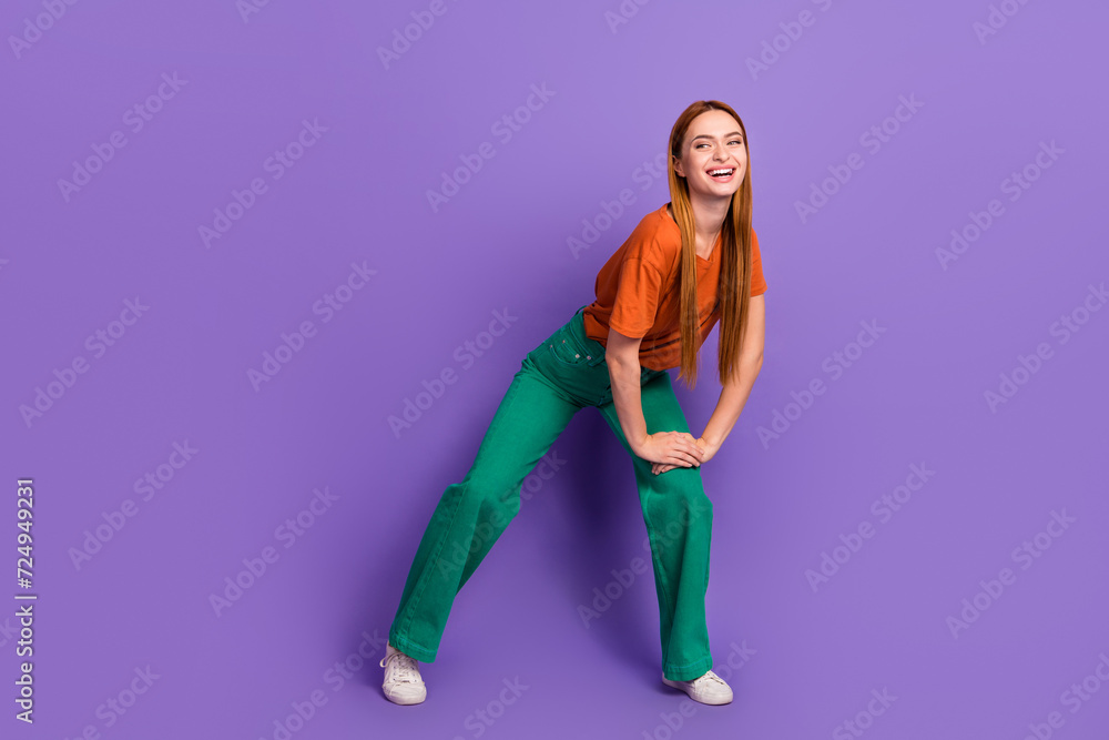 Full length photo of cheerful lovely girl wear trendy clothes look up empty space special sale news isolated on purple color background