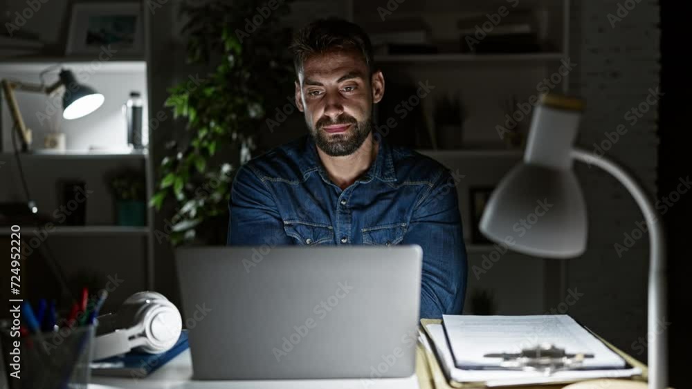 Smiling young hispanic man confidently shines in the office, joyfully rocking the business world, crossing his arms in relaxed triumph over his laptop. Smiling young hispanic man confidently shines in the office, joyfully rocking the business world, crossing his arms in relaxed triumph over his laptop.