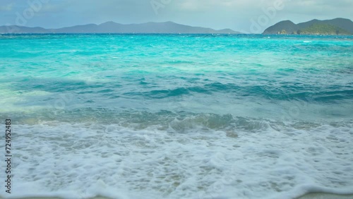 Gorgeous turquoise water and waves crashing gently on tropical beach