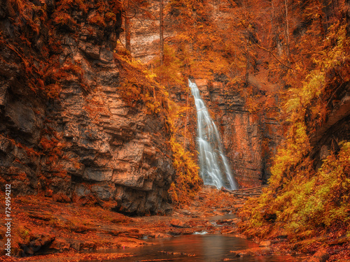 view to waterfall in canyon in autumn colours © sergejson