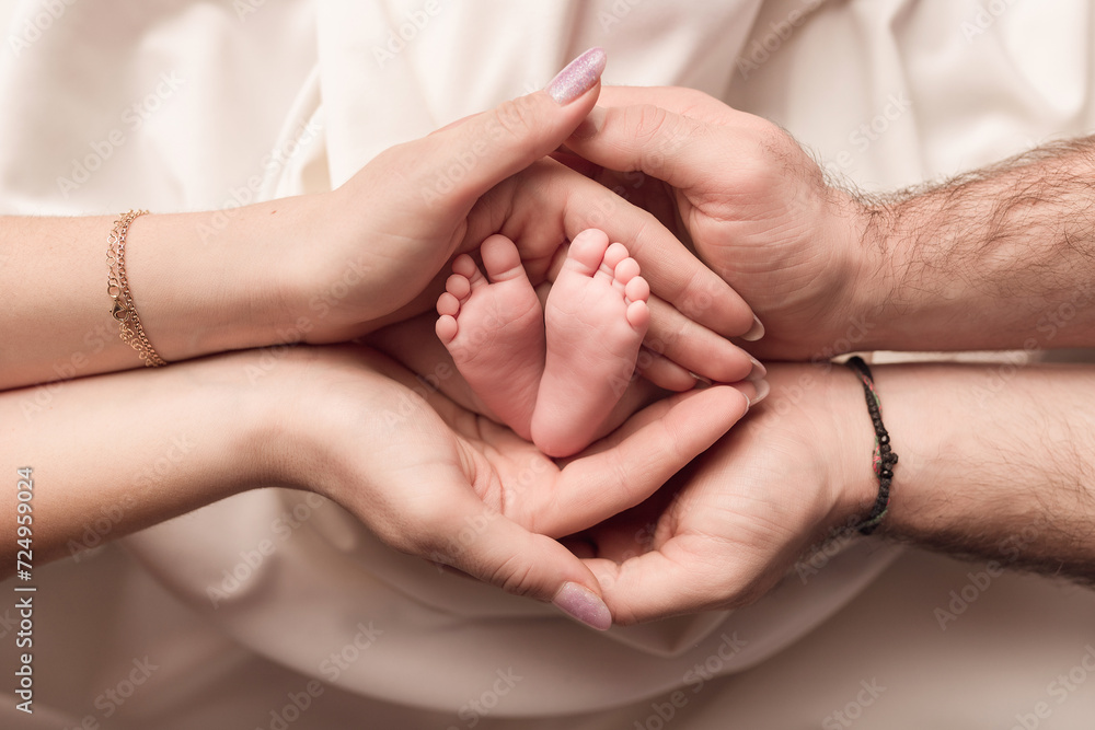 Children's feet in the arms of their parents. On a white background. Children's feet in the arms of their parents. On a white background.