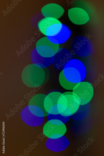 circles of lights in green and blue in circles on dark background