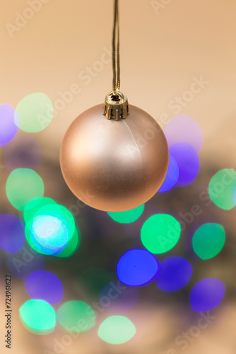 view of a hanging christmas ball and colored circles at the bottom of the image