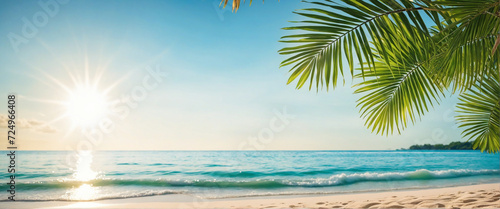 Beautiful beach of ocean, sea background. Palm leaves on tropical beach with bokeh sun light. Nature, summer vacation, travel concept