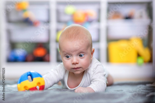 Baby reaching for toy. Baby development
