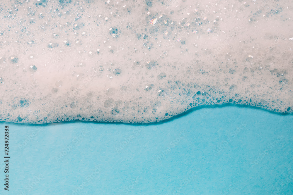 Soapy foam with bubbles on blue background Soapy foam with bubbles on blue background