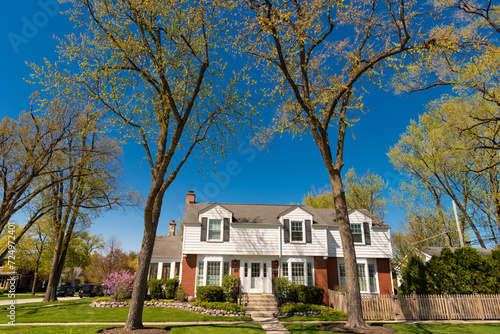 modern cottage house. property in neighborhood. residential building house outdoor. vintage cottage style home in residential neighborhood. neighborhood house architecture. residential building