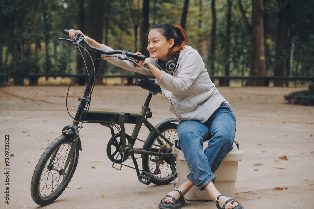 Happy Asian young woman walk and ride bicycle in park, street city her smiling using bike of transportation, ECO friendly, People lifestyle concept. Happy Asian young woman walk and ride bicycle in park, street city her smiling using bike of transportation, ECO friendly, People lifestyle concept.