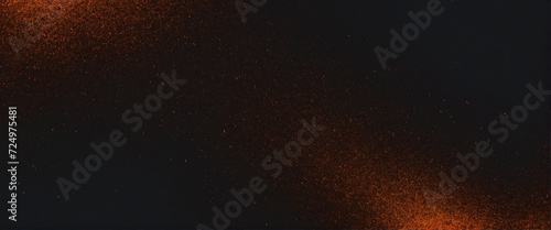 Deep hues of orange and black swirl in an abstract background of light and texture