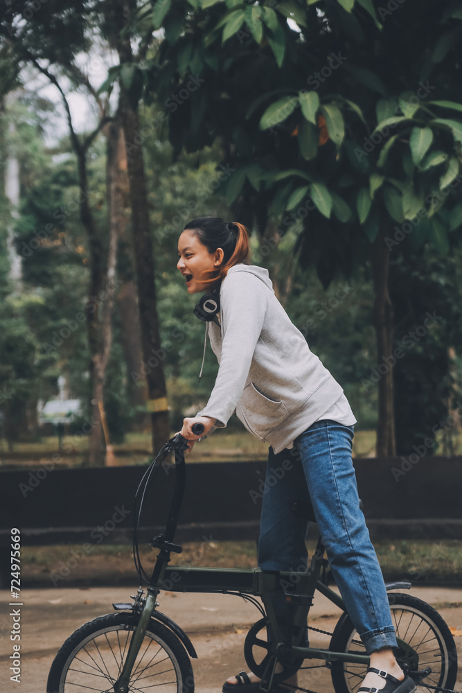Obraz premium Happy Asian young woman walk and ride bicycle in park, street city her smiling using bike of transportation, ECO friendly, People lifestyle concept.