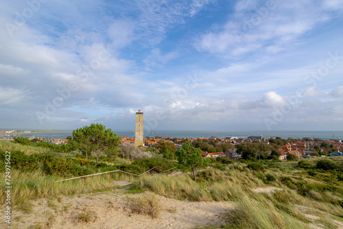 Small town in West-Terschelling under blue sky, Brandaris lighthouse (Vuurtoren Brandaris) on the Dutch Wadden Sea island Terschelling, A municipality and an island in northern Friesland, Netherlands.