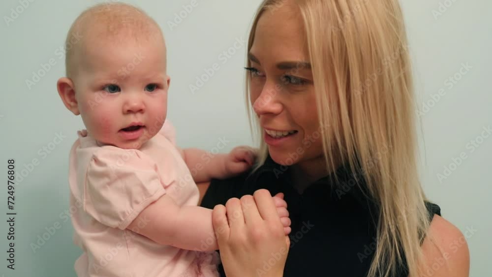 Happy young mother kisses her little cute baby, slow motion Happy young mother kisses her little cute baby, slow motion