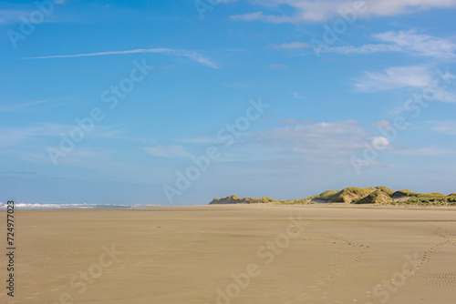 Landscape view of wide and long beach, White sand under blue sky and white puffy could, The Dutch Wadden Sea island Terschelling, A municipality and an island in the northern, Friesland, Netherlands.