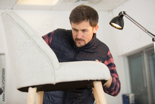 male artisan working on chair upholstery photo