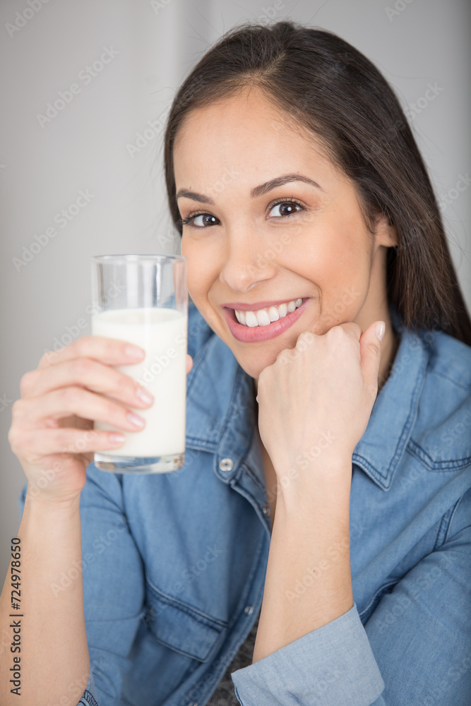 beautiful middle age woman holding glass of milk