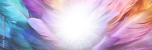 Multicoloured feather and star burst wide banner - angelic blue pink purplr orange turquoise coloured feathers radiating outwards with a white star light in the middle ideal for a spiritual theme photo