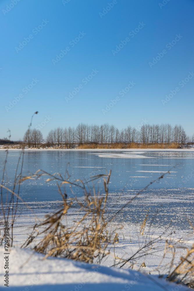 frozen lake covered with snow and ice in winter frozen lake covered with snow and ice in winter