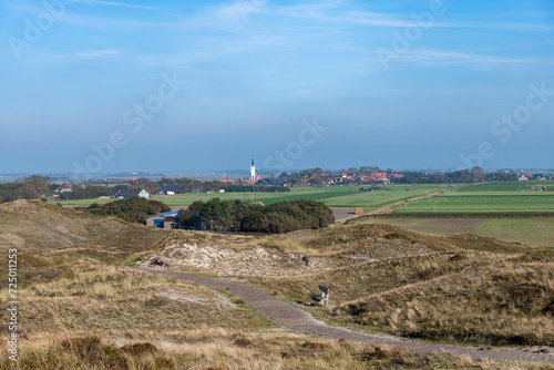 Panoramic view over the dunes in the southern part of Texel island, The Netherlands with in the background the city of Den Hoorn and its characteristic white church (Witte Kerkje)
