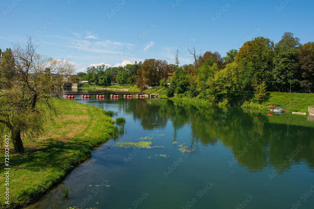 The Pjesacki Pontonski Most bridge spans the Kosana River as it passes through Karlovac in central Croatia. Early September The Pjesacki Pontonski Most bridge spans the Kosana River as it passes through Karlovac in central Croatia. Early September