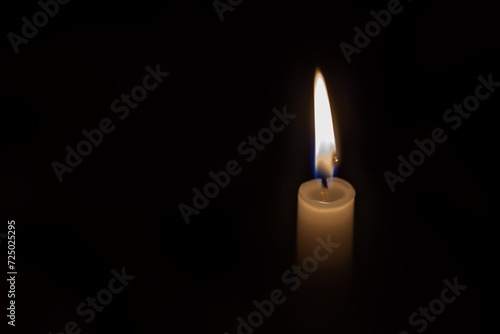 Paraffin candle on a black background