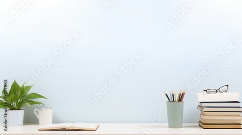 A Desk With Books, Glasses, and a Plant. Copy space