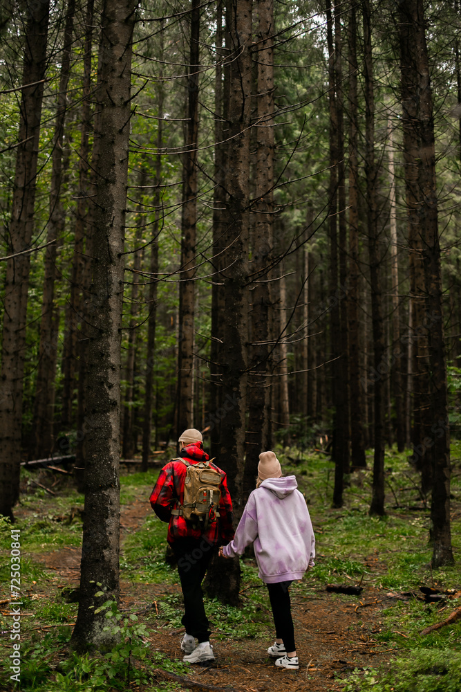 Fototapeta premium Couple walking in mountain forest