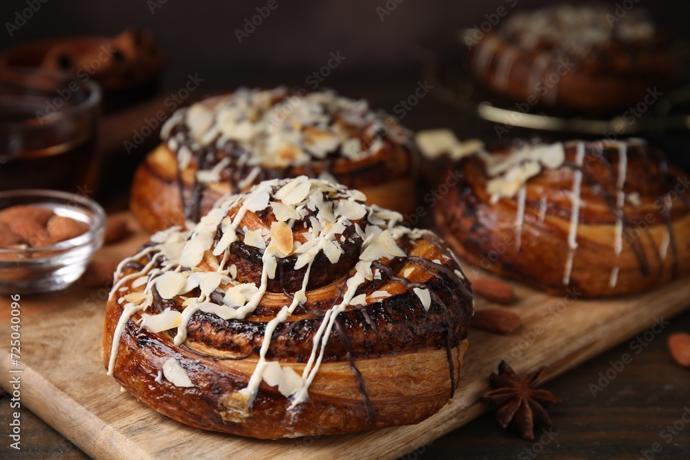 Delicious rolls with toppings and nuts on wooden table, closeup. Sweet buns Delicious rolls with toppings and nuts on wooden table, closeup. Sweet buns