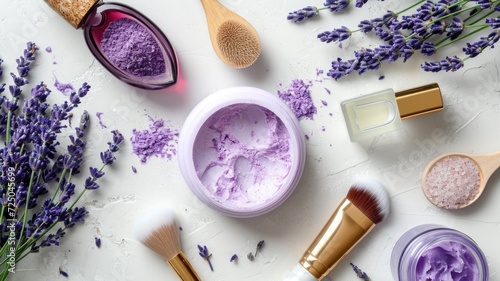 Beauty products infused with lavender and fresh sprigs on marble. photo