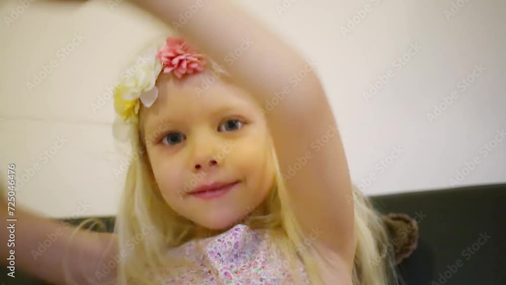 Girl in a floral rim swings a pillow and throws it away Girl in a floral rim swings a pillow and throws it away