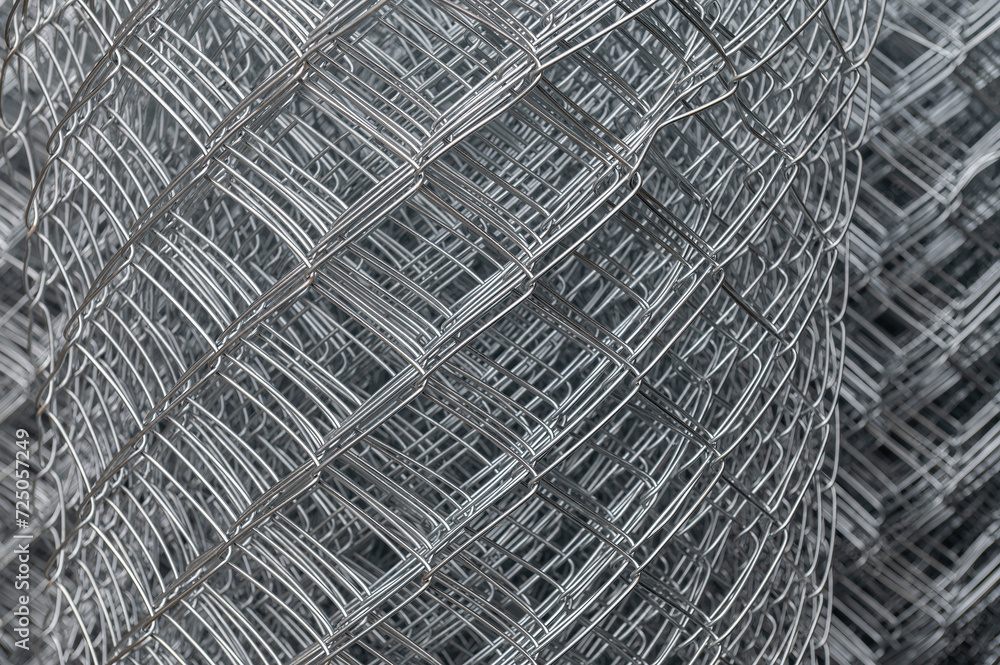 Roll of metal mesh. Rolled metal mesh netting. Rolled chain link fence. Selective focus. Roll of metal mesh. Rolled metal mesh netting. Rolled chain link fence. Selective focus.